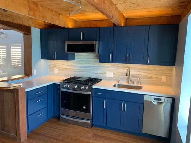 A kitchen with a table and chairs and a sink
