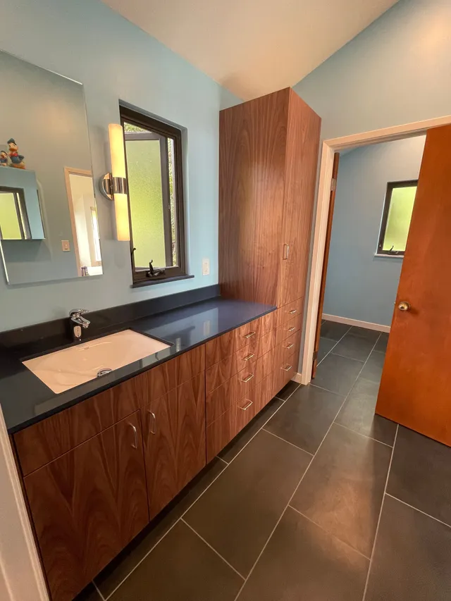 A kitchen with a table and chairs and a sink